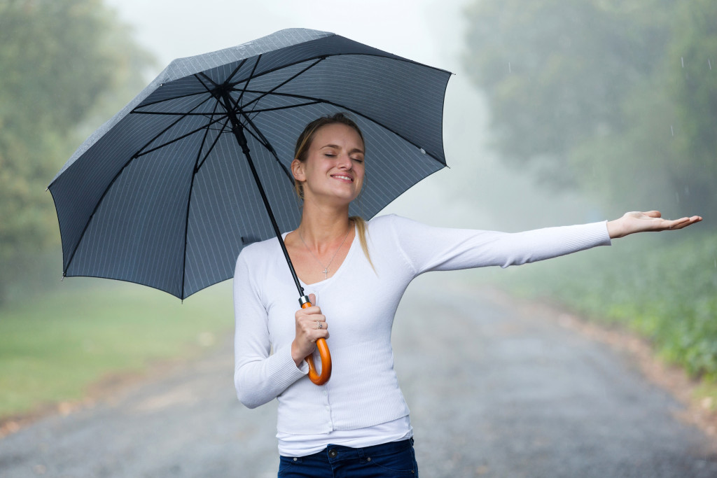 woman with umbrella enjoying the rain
